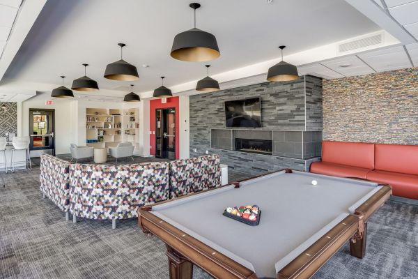 The Edge Game room at the Park at the Edge apartments in San Diego, featuring gaming tables and comfortable seating areas.