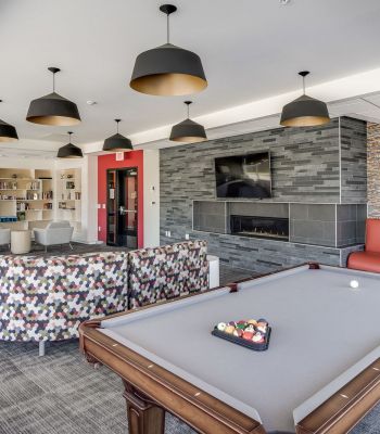 The Edge Game room at the Park at the Edge apartments in San Diego, featuring gaming tables and comfortable seating areas.
