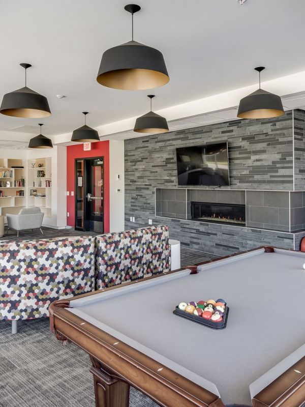The Edge Game room at the Park at the Edge apartments in San Diego, featuring gaming tables and comfortable seating areas.